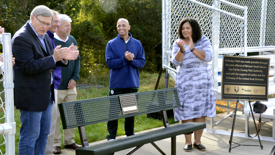 ribbon cutting over park bench