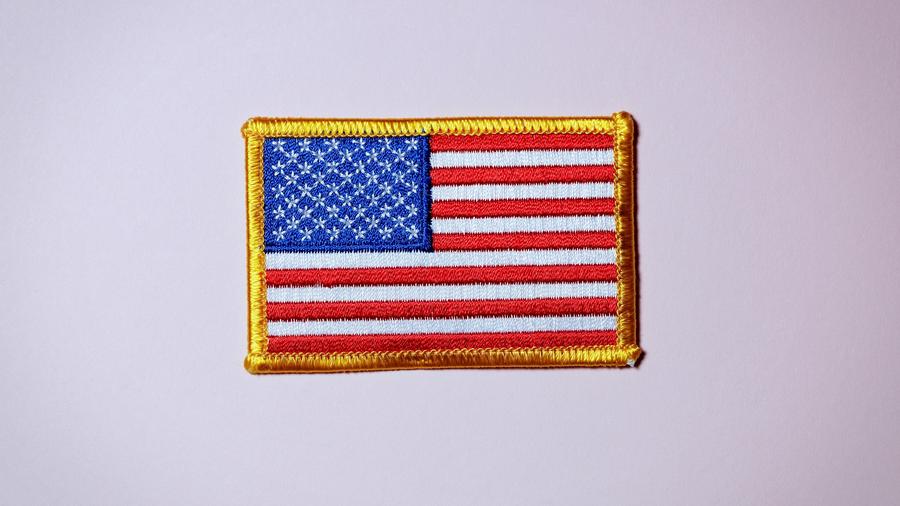 An American flag patch with a golden outline