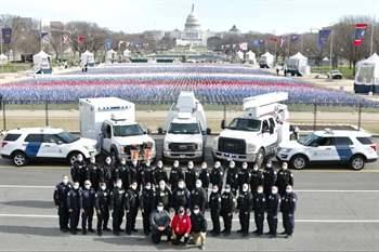 military in front of police vehicles