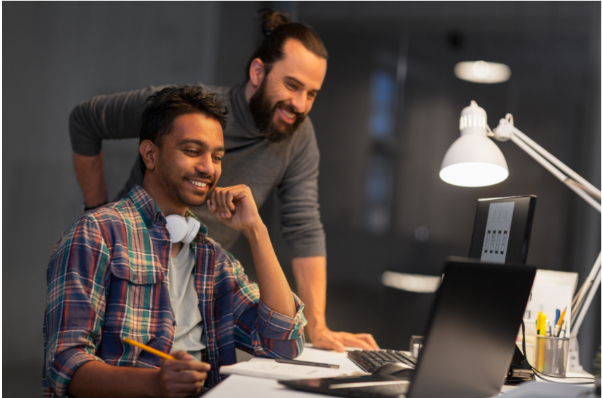 Two men working at a computer