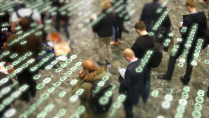 crowd of people on their devices unknowingly having their information compromised