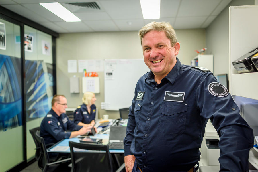 Man in pilot uniform smiling at camera