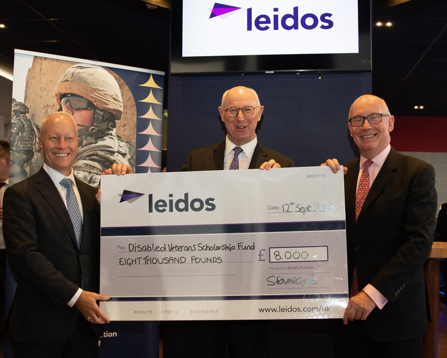 Leidos leadership team present cheque to Disabled Veterans Scholarship Fund