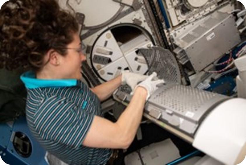 Astronaut Christina Koch places blood samples into MELFI freezer for future return to Earth for analysis