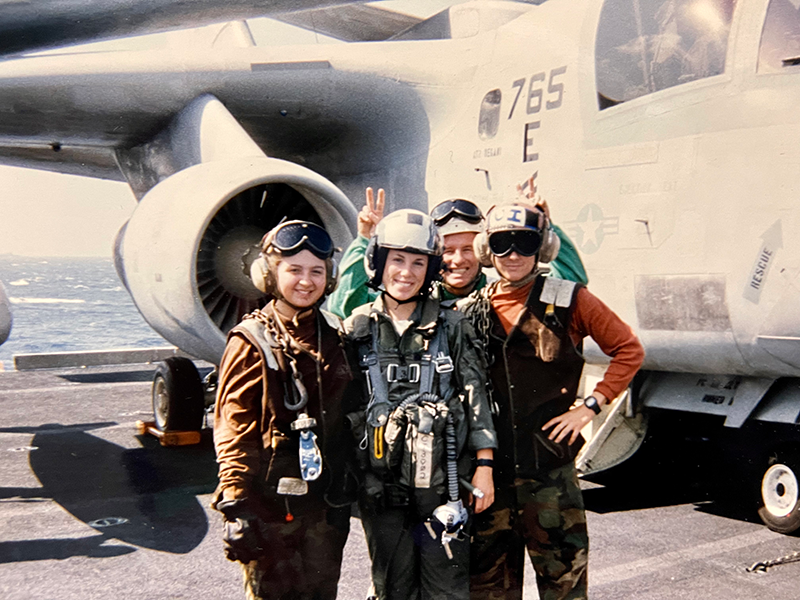 Lisa with colleagues in front of Navy plane