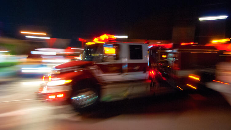 Stylized motion-blurred image of a fire truck en route.