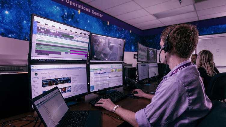 Leidos employee working at computer screens in operations center