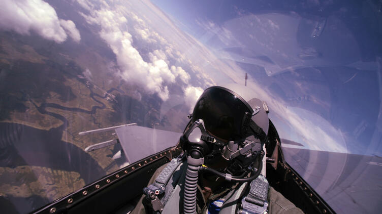 pilot with view of sky behind