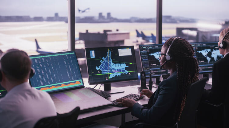 Workers sitting at flight deck looking at screens