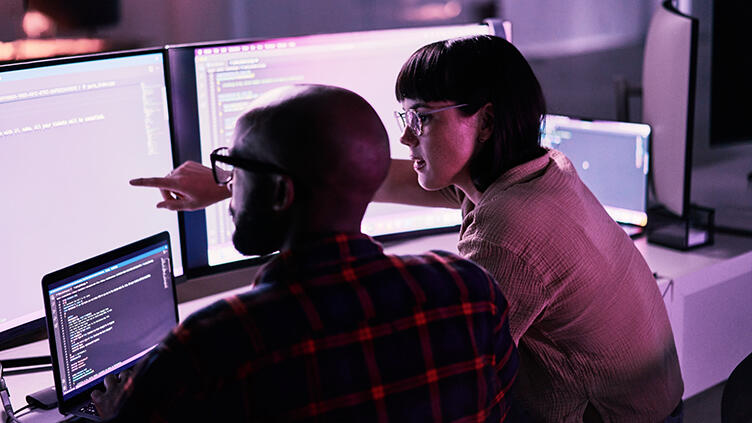 Two people work on a computer