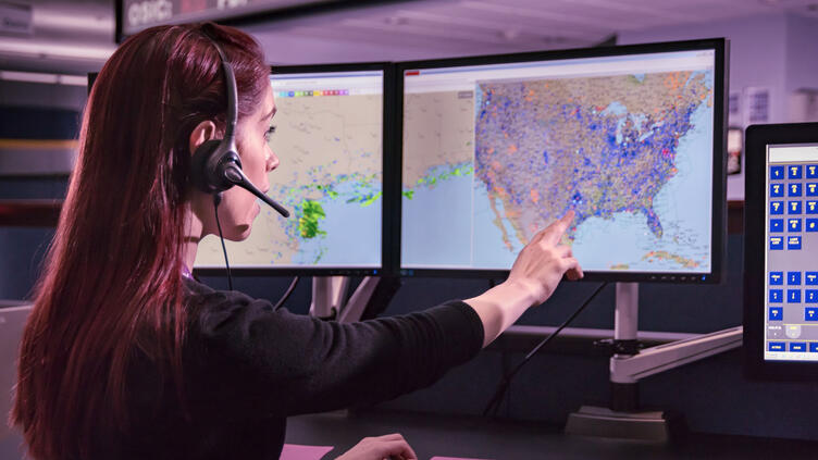 Flight services woman pointing at screen