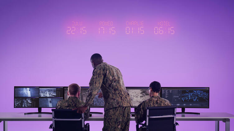 team from behind while working on screens