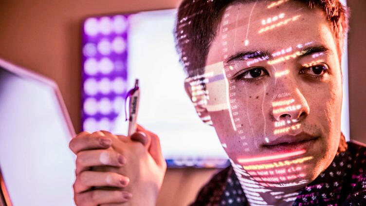 Computer screen reflecting on a mans face Computer screen reflecting on a man's face