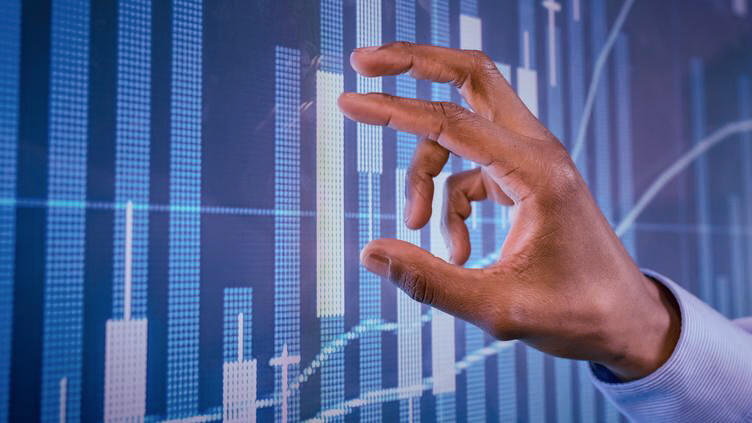 Fingers on a screen with a chart