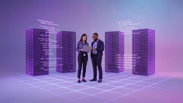 two people stand in front of servers