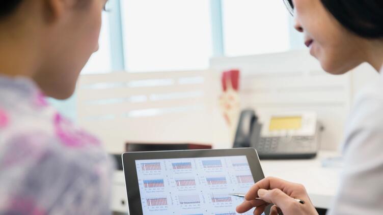 Two people working on tablet