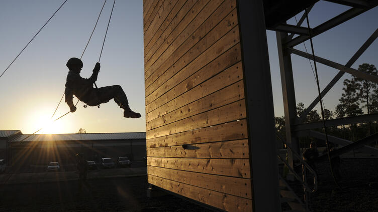 Person scaling obstacle course wall