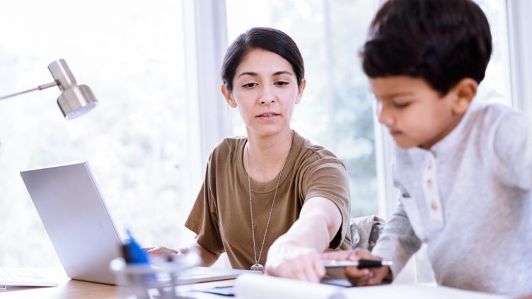 Woman and child at computer desk doing homework together