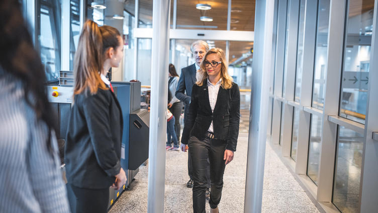 woman walking through metal detector