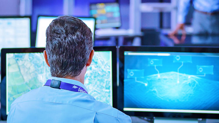 Man in front of computer screen analyzing data