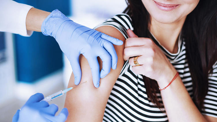 Female patient receiving immunization