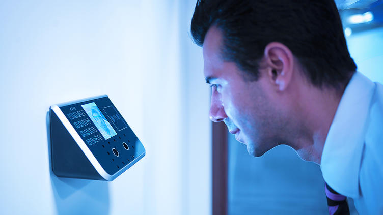 man leaning into scanning keypad