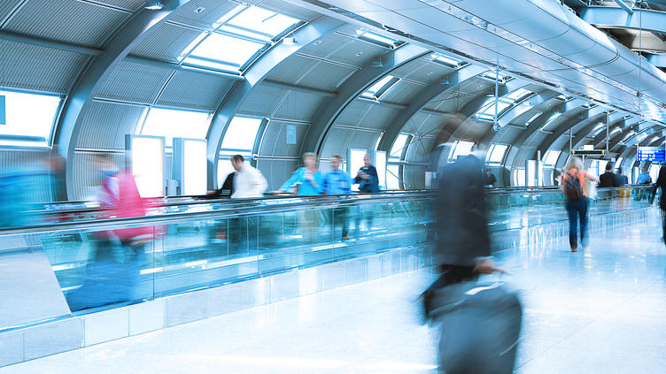 people walking on people-mover at airport