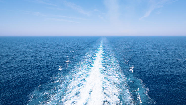 ripples in the ocean from boat moving through