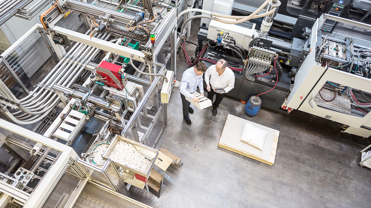 view from overhead of two coworkers in a stock room