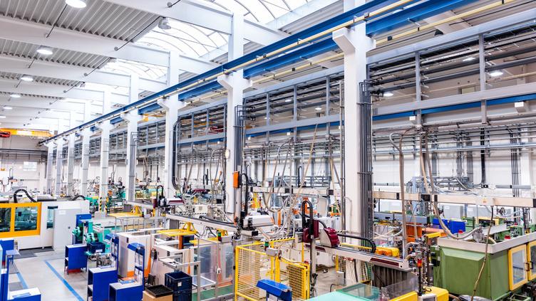 Plant floor filled with heavy machinery, no workers present