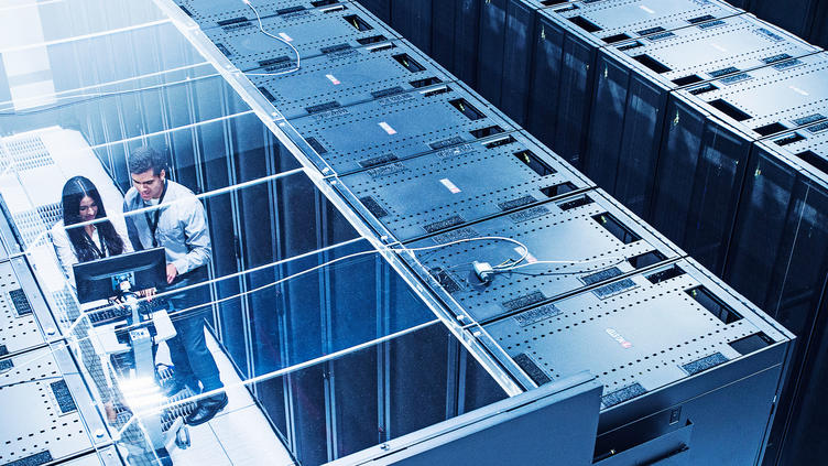 aerial view of two coworkers in server room