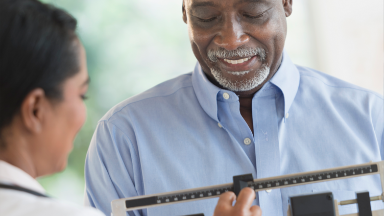 Doctor examining patient on scales