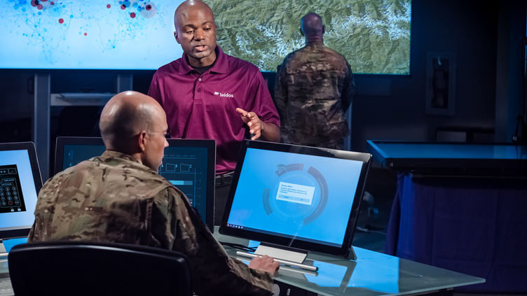 two men having conversation over computer screen