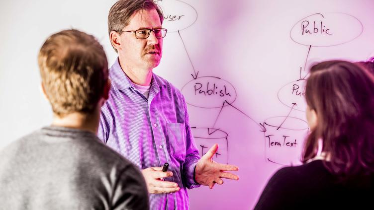 man teaching on a whiteboard